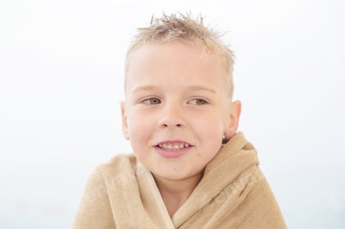 Preview: Blond Boy In Towel On The Beach