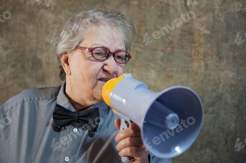 Preview: Beautiful Senior Woman Is Excited, Euphoric, Screaming With Megaphone, Sign Of Revolution And