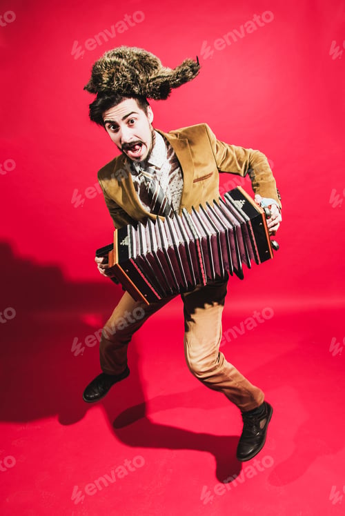Preview: Positive Man With Accordion Posing In Studio