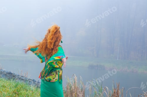 Preview: Woman With Red Hair In Green Fress, In Autumn Park