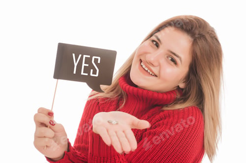 Preview: Beautiful Blonde Woman Holding Engagement Ring And Cardboard Sign On Stick With Yes On It. Marriage