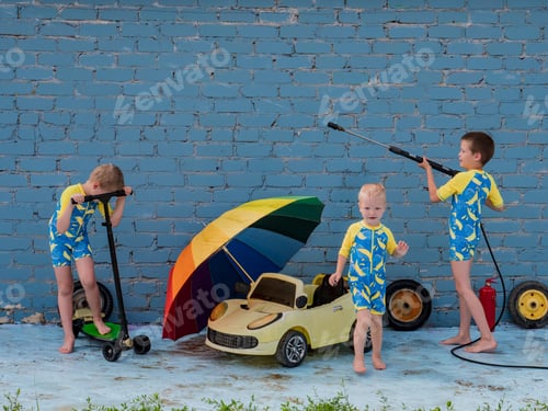 Preview: Funny Children In Boys' Bathing Suits Posing In Front Of Camera With High-Pressure Car Wash And Toy