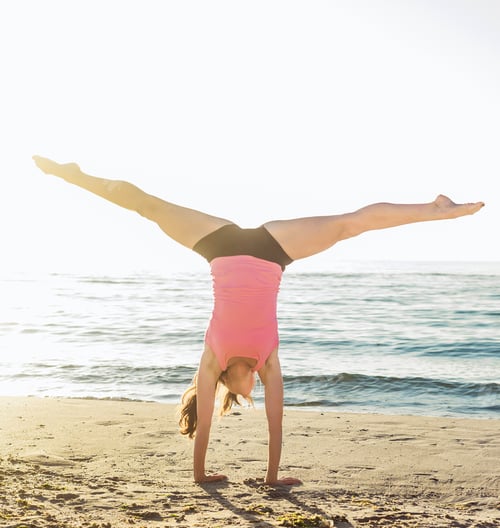 Preview: Young Caucasian Female Doing Exercises On The Seaside During The Sunrise. Workout On Beach