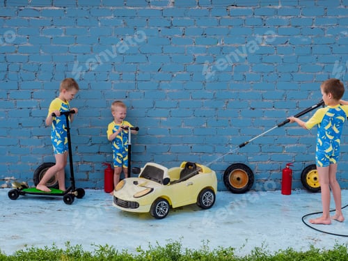 Preview: Funny Children In Boys' Bathing Suits Posing In Front Of Camera With High-Pressure Car Wash And Toy