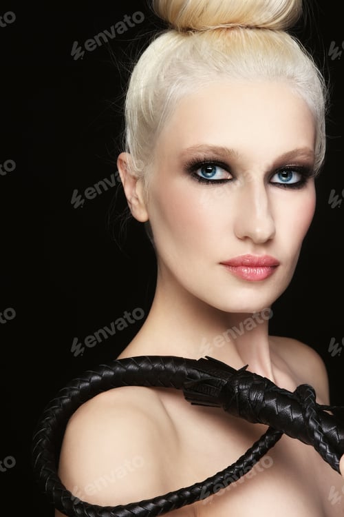 Preview: Young Beautiful Blond Woman With Braided Bull Whip In Her Hand