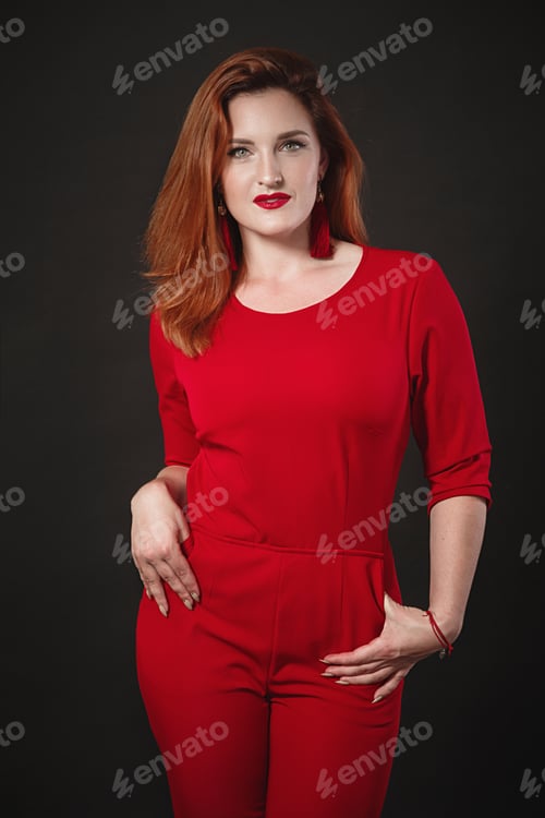 Preview: Smiling Woman Portrait. Girl Wearing Red Overalls. Black Background.