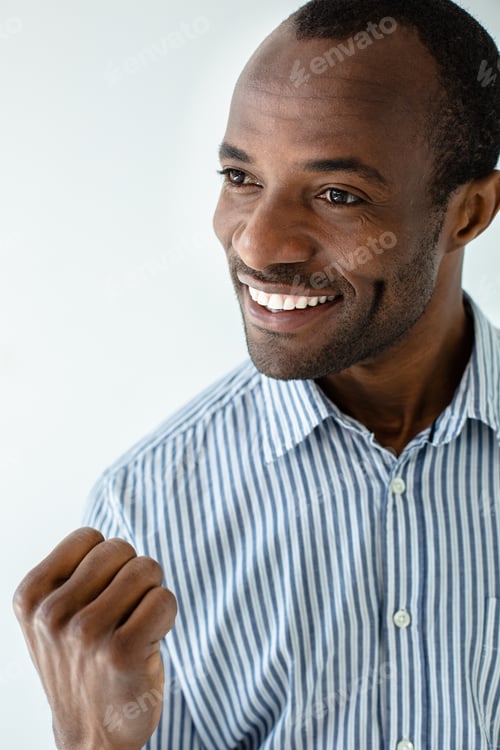 Preview: In A Good Spirit. Optimistic Afro Americn Man Feeling Lucky Against White Background