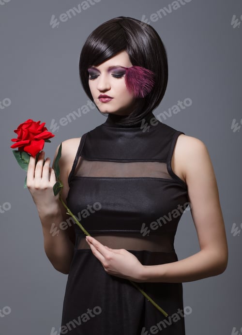 Preview: Luxury Young Woman With A Red Rose In His Hands. Fashion Photo .