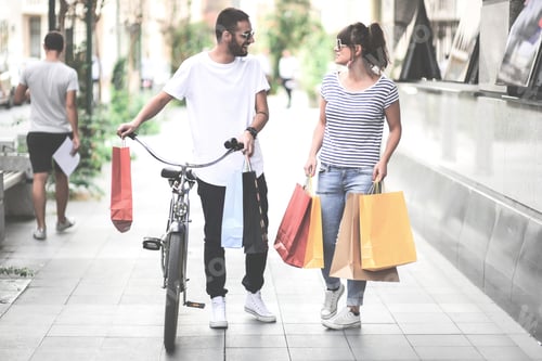 Preview: Beautiful Couple Shopping In The City Walking And Holding Shopping Bags. Shopping Concept