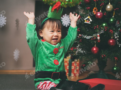Preview: Baby Girl Decorating Christmas Tree
