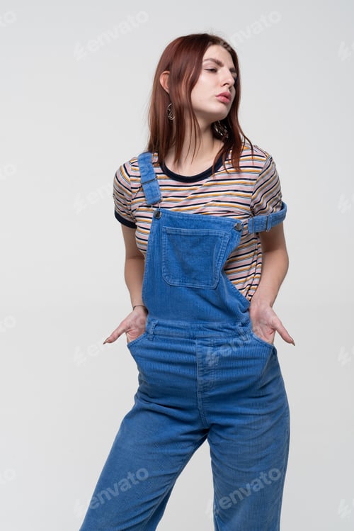 Preview: Young Beautiful Girl Stands In Blue Overalls