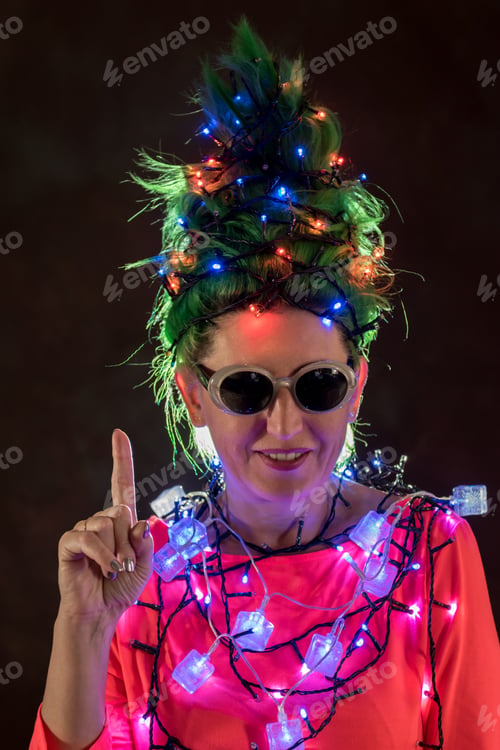Preview: A Beautiful Girl In A Pink Dress With Green Hair Decorated Herself With Christmas Garlands. Her