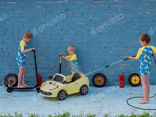 Preview: Funny Children In Boys' Bathing Suits Posing In Front Of Camera With High-Pressure Car Wash And Toy