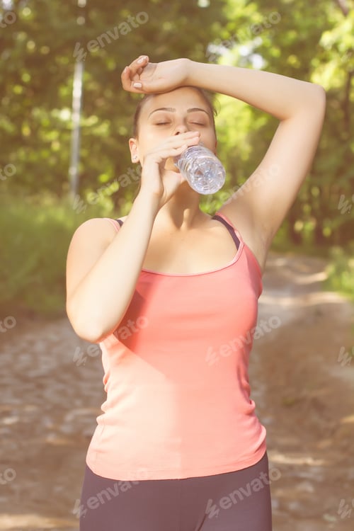 Preview: Fitness Healthy Young Woman Drinking Water After Exercising Outdoor.