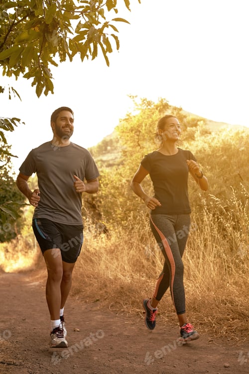 Preview: Running Young Couple In Shadows With Sun Light Behind Them While Wearing Black And Grey Jogging