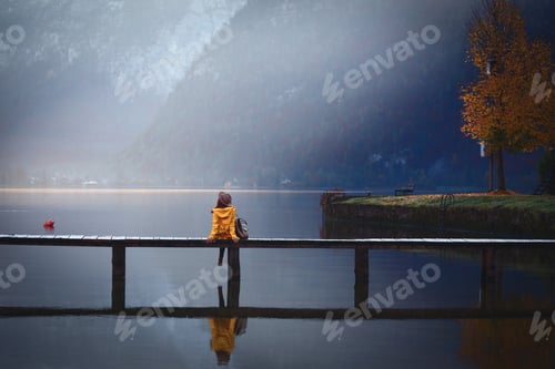 Preview: Girl Stands On A Wooden Bridge On A Mountain Lake In The Early Morning. Beautiful Landscape And