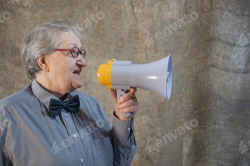 Preview: Beautiful Senior Woman Is Excited, Euphoric, Screaming With Megaphone, Sign Of Revolution And