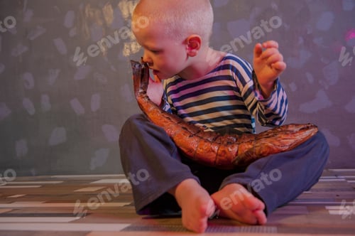 Preview: Little Blond Boy Shows Big Smoked Fish. Child Wants To Catch Big Fish In Ariver. Concept Of Organic