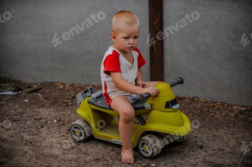 Preview: Rustic Boy In T-Shirt Play In Farmyard On Background Of Sunset. Child Is Happy In Village On