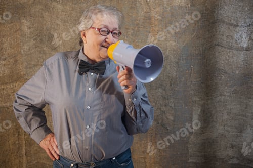 Preview: Beautiful Senior Woman Is Excited, Euphoric, Screaming With Megaphone, Sign Of Revolution And
