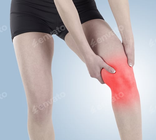 Preview: Acute Pain In A Knee. Woman Holding Hand To Spot Of Knee-Aches.