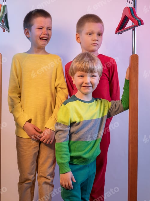 Preview: Cute Blond Boys In Red, Yellow And Green Sweaters At Home. Teenagers Climbed Into Locker Room And