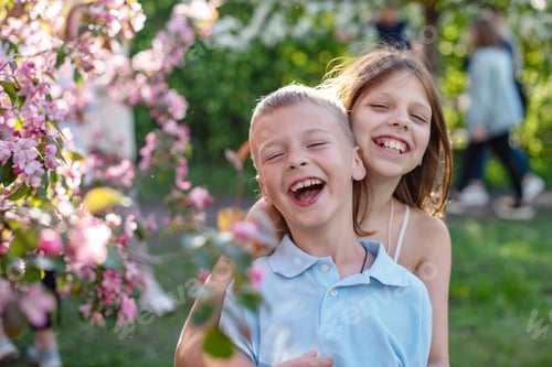 Preview: Candid Portrait Of A Boy And A Girl In A Blooming Apple Orchard