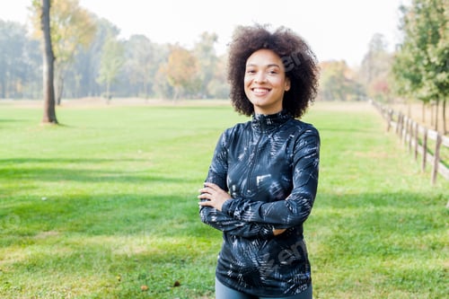 Preview: Portrait Of Happy Fitness African Woman Relaxing After Exercise On Green Fields In The Morning
