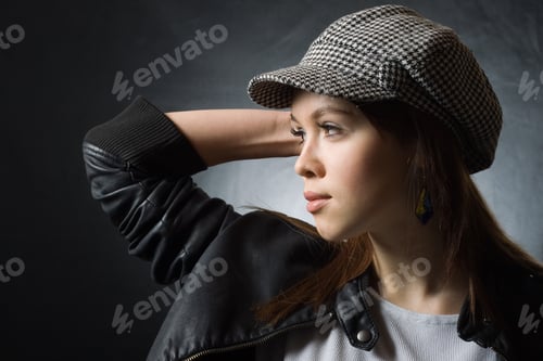 Preview: A Pretty Girl In A Cap On A Dark Background.