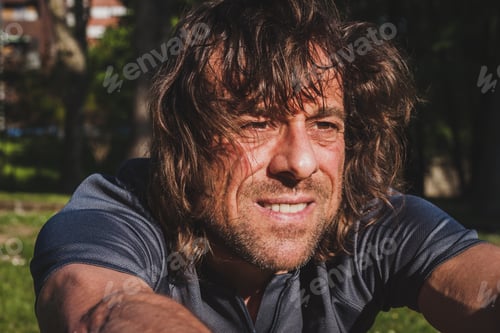Preview: Mature Long Haired Athlete Stretching In A City Park