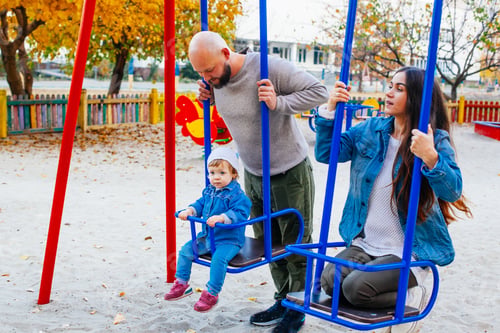 Preview: Happy Family With Little Kid On The Children Ground Playing All Together
