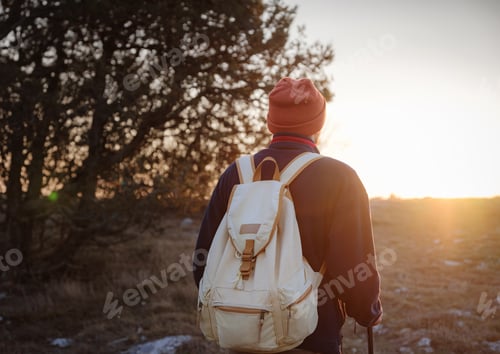 Preview: A Young Man Standing On Top Cliff In Spring Mountains At Sunset And Enjoying View Of Nature
