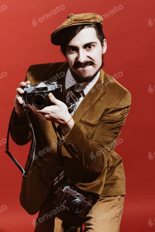 Preview: Very Positive Photographer Posing In Studio With Camera