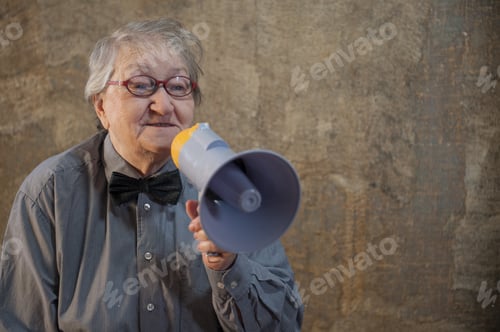 Preview: Beautiful Senior Woman Is Excited, Euphoric, Screaming With Megaphone, Sign Of Revolution And