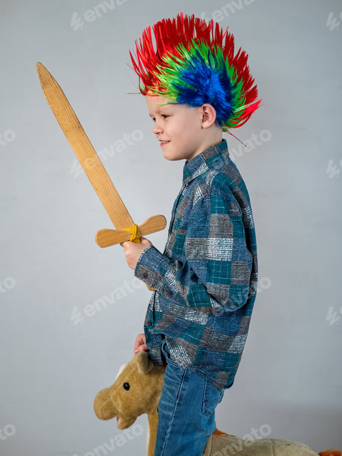 Preview: Happy Boy In Plaid Shirt Is Rolling On Rocking Horse Toy. Baby With Wonderful Punk-Style Colored