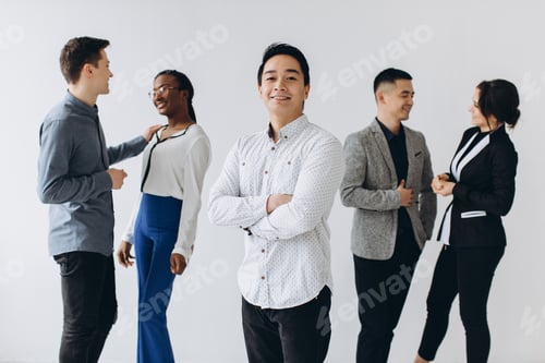 Preview: Cheerful Multiracial Professional Business People Laughing Together Standing In Row Near Wall