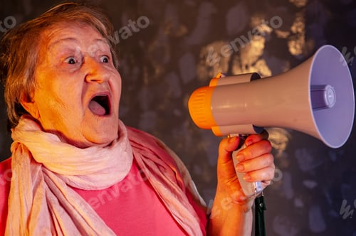 Preview: Beautiful Senior Woman Is Excited, Euphoric, Screaming With Megaphone, Sign Of Revolution And