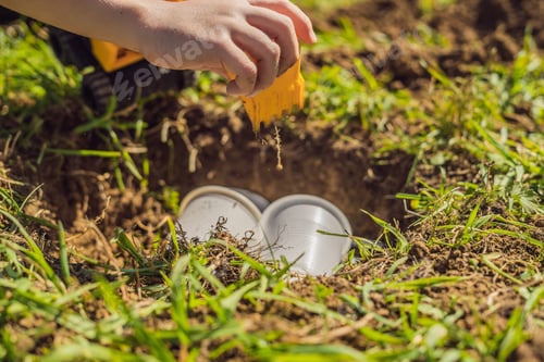 Preview: The Boy Plays Recycling. He Buries Plastic Disposable Dishes And Biodegradable Dishes