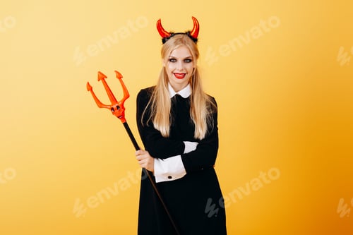 Preview: Devil Woman Standing Against A Yellow Background