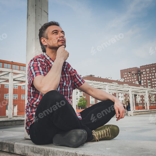Preview: Man In Short Sleeve Shirt Sitting Outdoor With Crossed Legs