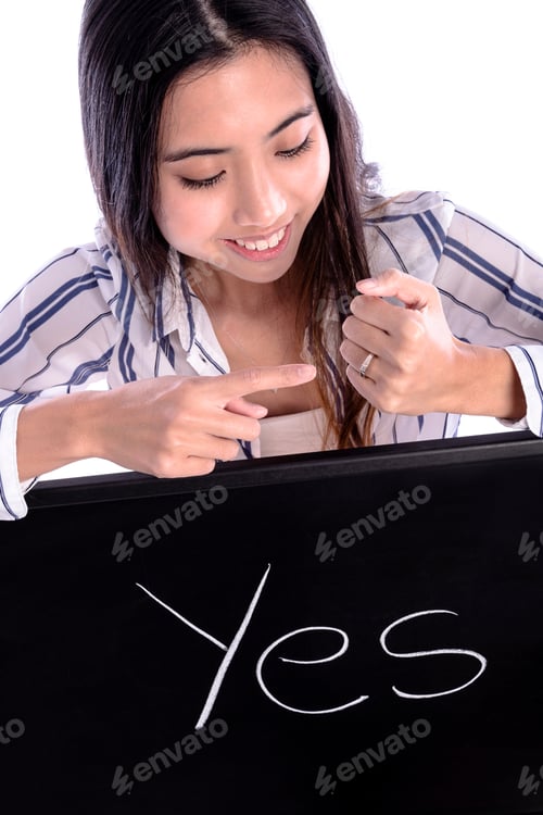 Preview: Beautiful Asian Female Model Pointing On Wedding Ring On Her Hand And Holding Blackboard Sign With