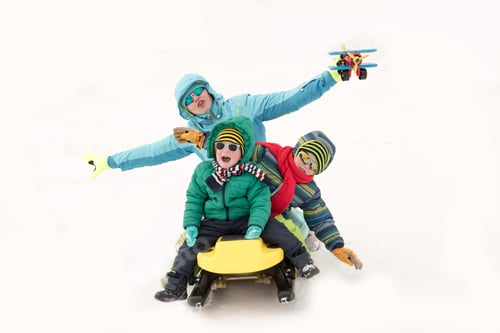 Preview: Young Girl In A Blue Ski Suit Plays In The Snow With Her Children. Yellow Sledges, Sunglasses