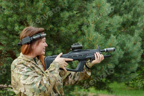Preview: Woman In Camouflage Playing In Laser Tag Shooting Game With A Weapon Outdoor