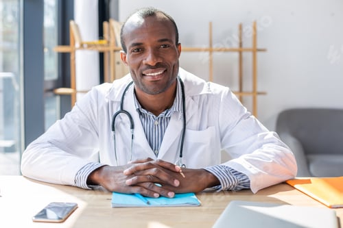 Preview: Waiting For Visitor. Handsome International Doctor Expressing Positivity While Keeping Stethoscope