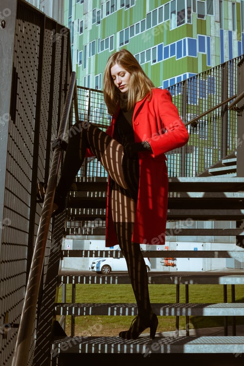 Preview: Beautiful Girl Posing In The Street With Red Coat