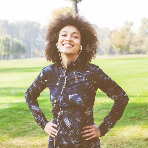 Preview: Portrait Of Afro Fitness Happy Woman Listening Music After Exercise In Nature And Ready For