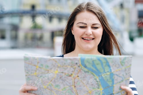 Preview: A Woman With A Map In Her Hands Walks The Streets Of The City, Looking For The Right Path