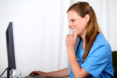 Preview: Portrait Of A Beautiful Blonde Nurse Working On Computer At Hospital