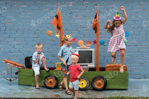 Preview: Happy Brothers In Colored Clothes And Girl Celebrate Birthday Of Youngest Boy On Pirate Ship. Girl