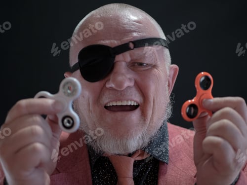 Preview: Portrait Of Strange Elderly Man Spinning Spiner On His Nose. Fancy Pensioner In Pink Jacket And Tie